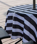 Outdoor Round Tablecloth 60 Inch With Zipper Umbrella Hole Water Resistant Polyester Durable Patio Garden Table Cover For BBQs And Parties Easy To Clean Shrink Resistant Black on a patio table.