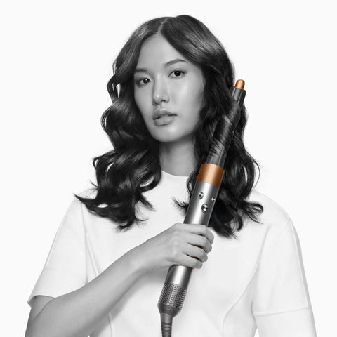 Woman holding Airwrap Origin Multi Styler With No Heat Damage, 1.2 Inch Barrel, Round Brush And Flyaway Attachment