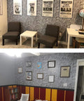 Dark Grey Castle Stone Peel And Stick Wallpaper Roll 20m in a living room with framed posters and chairs, showcasing rock texture.