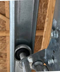 Close-up of Built To Last Heavy Duty Garage Door Vertical Track Rails 76 Inch Or 88 Inch Lengths Sold In Pairs Fits 7 Foot Doors Made In USA Galvanized Steel Durable US Steel Rails For Garage Door System installed in a garage.