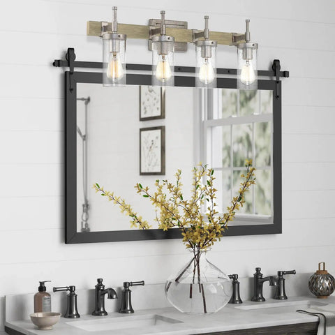 Winslow 28 Inch 4 Light Farmhouse Vanity Light with seeded glass shades above a bathroom mirror with bleached oak finish and galvanized steel accents.