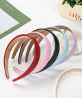 Wide 1 Inch Ultra Soft PU Leather Headband For Women Girls Comfortable Padded Faux Hair Band in various colors arranged together.
