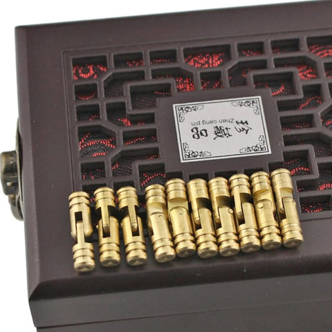 Close-up of 10 Piece Mini Brass Barrel Hinges Set For DIY Projects on a decorative box, 5x25mm, yellow brass