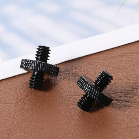 Solid Grip Six Pack Of One Quarter Inch Male To Male Threaded Tripod Screw Adapters For Camera Cages And Lighting Stands With Grippy Knurling And Rust Proof Aluminum Build Setup on a brown surface.