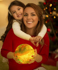Mother and daughter holding 7.1 Inch Galaxy Moon Lamp 3D Printed Moon With NASA Imagery, glowing in cozy living room