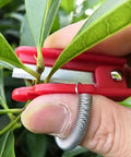 Thumb Knife And Pruning Shears For Leaf Trimming And Fruit Picking In The Garden Lightweight Snips With Precision Stainless Steel Blades And Ergonomic Grip For Easy One Hand Use Indoors And Outdoors Red in use trimming leaves