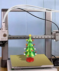 3D printer setup with 16.4Ft PTFE Teflon Tube Kit 2.5mm ID X 4mm OD for 1.75mm filament, featuring Christmas tree model print.