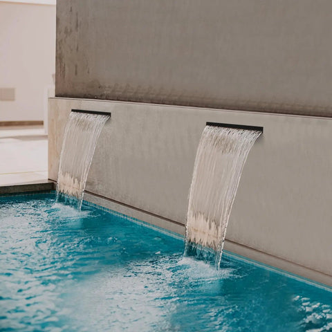 All-In-One Pond Waterfall Kit With LED Lights, 8-Inch Stainless Steel Spillway, in use over a pool edge