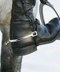 Close-up of Lightweight Zinc Alloy Dressage Spurs with 20mm Neck and Rotatable Rowel on riding boot during eventing