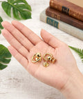 Top Shelf Gold Brass D Rings For Purse 4 Pack With Screw Back Rotatable Strap Hardware Absolutely Solid Build showing two rings in hand.