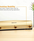 Gold 3 Hole Punch For 12 Sheets Durable Metal Office Punch With Stable Rubber Base on desk next to plants