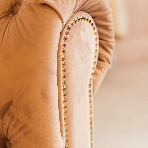 Smooth Upholstery Nailhead Trim Tape 8 Meter Glossy Bronze Decorative Strips adorn a soft beige chair back with shiny nails.