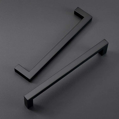 Solid Zinc Alloy 5 Inch Black Cabinet Handles And Drawer Pulls For Kitchen Refresh Slick Rust Proof Finish Heavy Duty Hardware Top Shelf Quality In A 25 Pack viewed from above on a gray background.