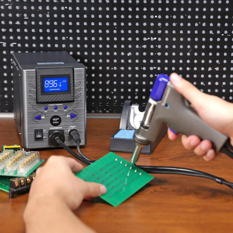 Person using Beast 110W Desoldering Station With Four Nozzles Temperature Controlled Three Preset Channels Tiltable Display on PCB