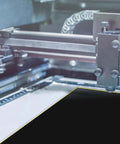 Black laser engraving marking paper sheet on a laser cutter bed, 39×27 cm.