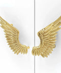 Heavy Duty Solid Brass Wardrobe Handles Featuring Slick Matte Gold Angel Wing Design And Badass Cabinet Knobs on a white cabinet door.