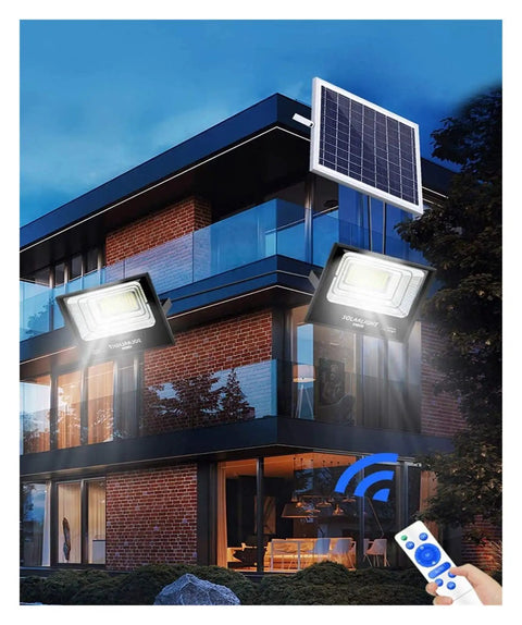 Top Shelf Led Solar Flood Light With Remote Control And Dusk To Dawn Auto Sensor IP67 Waterproof mounted on building exterior.