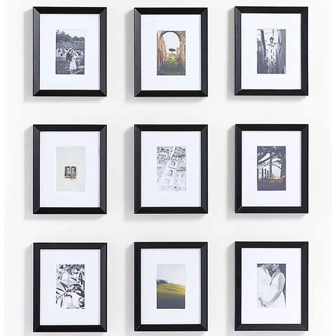 Wall with nine framed pictures in a 3x3 grid layout, featuring black frames and various images on a white background.
