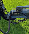 Installed 10 Pack Quarter Inch Trailer Hitch Pin Set With Quick Release And Locking Pin securing tow hitch on grassy field.