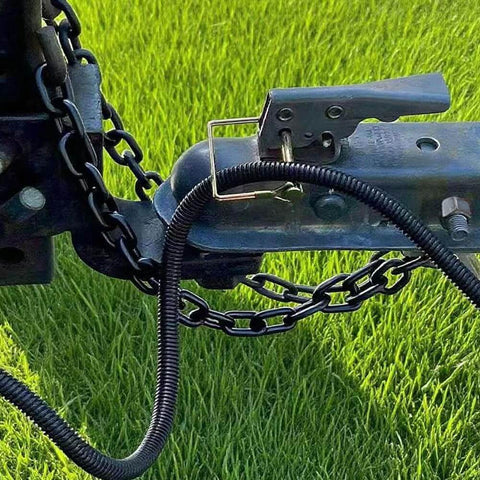Installed 10 Pack Quarter Inch Trailer Hitch Pin Set With Quick Release And Locking Pin securing tow hitch on grassy field.