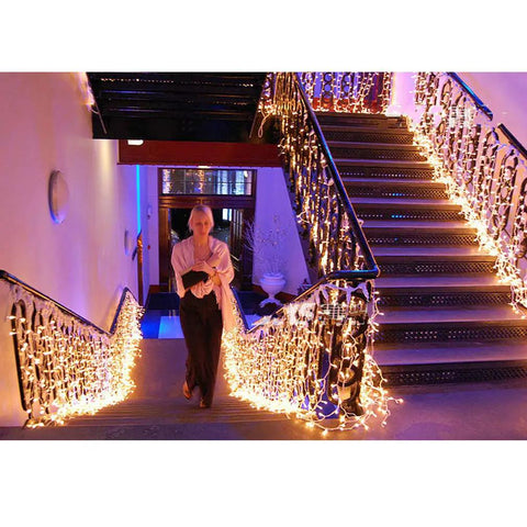 Warm White LED Icicle String Lights For Windows And Outdoor Spaces 16.4Ft 216 LEDs illuminating a staircase in 8 modes