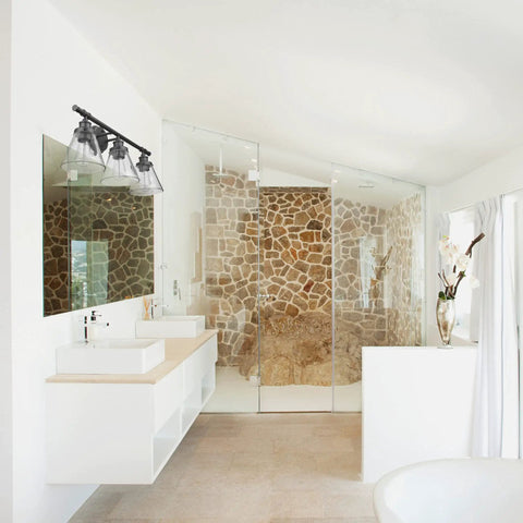 Bathroom with Three-Light Vanity Fixture in Oil Rubbed Bronze with Clear Glass Shades over mirror, complementing modern decor.
