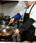 Chef using Legit Flame Resistant Welding Sleeves And Built Different Cotton Arm Guards Offering Heavy Duty Heat Protection For Serious Shop Work And Mechanic Hustles while cooking.