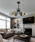 Six Light Glass Globe Sputnik Chandelier Modern Metal Black Ceiling Light Fixture in a living room above a coffee table.