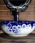 USZWBY Vessel Sinks Blue and White Porcelain Bathroom Basin Sink round ceramic sink with floral design and faucet.