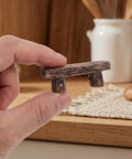 4 Pack Miniature Resin Park Benches for Fairy Gardens and Dollhouses, shown as a small rustic bench held in hand.