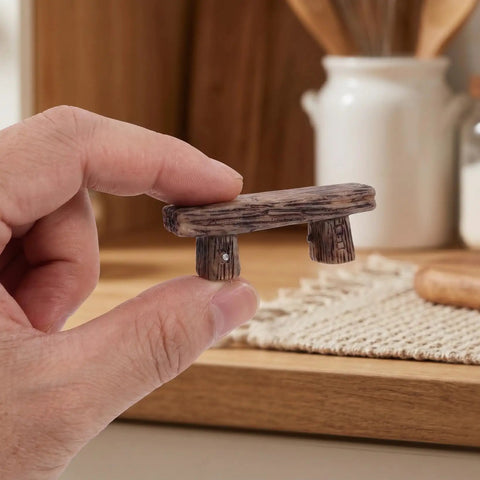 4 Pack Miniature Resin Park Benches for Fairy Gardens and Dollhouses, shown as a small rustic bench held in hand.