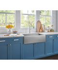 Blue kitchen cabinets with Sanctuary II 7 Inch Bar Pull TK252BSN Brushed Satin Nickel Modern Metro Style handles, marble countertop and farmhouse sink.