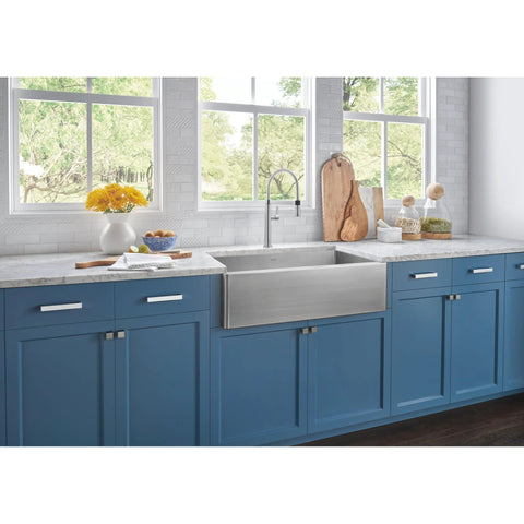 Blue kitchen cabinets with Sanctuary II 7 Inch Bar Pull TK252BSN Brushed Satin Nickel Modern Metro Style handles, marble countertop and farmhouse sink.