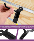 Close-up of a black 4-inch slatwall hook being installed on a wooden panel, part of the 20 Piece 4 Inch Heavy Duty Slatwall Hooks Kit For Garage Organization And Retail Display Slatwall Panel Hooks Gridwall And Pegboard Compatible Black Finish Durable Storage Hooks Set.
