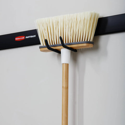 Broom mounted on FastTrack Wall Mounted Utility Hook for Rope Hose and Tools Garage Storage With Soft Grip Coating Mounted to rail