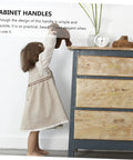 Child reaching for vintage dresser with Dragonfly Cabinet Knob Set For Dresser Drawers And Cabinet Doors Vintage Gold Antique Brass Copper Finish Dragonfly Handles Stylish Drawer Pulls For Wardrobe Desk Bookcase And Furniture Makeover visible.