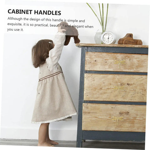 Child reaching for vintage dresser with Dragonfly Cabinet Knob Set For Dresser Drawers And Cabinet Doors Vintage Gold Antique Brass Copper Finish Dragonfly Handles Stylish Drawer Pulls For Wardrobe Desk Bookcase And Furniture Makeover visible.