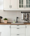 Modern kitchen with white cabinets featuring 12 Pack Square Cabinet Handles 4.5 Inch Center To Center Matte Black Drawer Pulls.