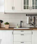 White kitchen cabinets with 30 Pack Four And A Half Inch Square Kitchen Cabinet Handles Matte Black Pulls for cupboards and drawers.