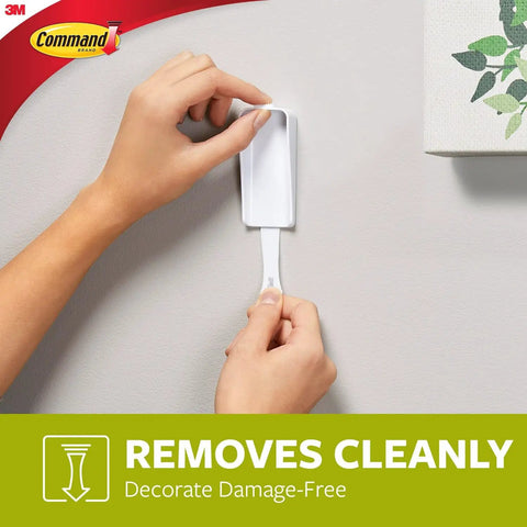Person removing Damage Free Canvas Hanger Kit With No Tools Wall Hooks For 18x24 Art Canvases showing clean removal