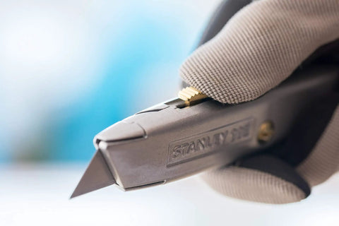 Close-up of everyday utility knife with retractable blade for safe precise cutting, showing non-slip handle and durable silver design