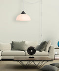 Living room with modern furniture and 1 Light Plug-In Pendant Light In Dark Bronze With Frosted Shade And Adjustable Clear Cord Height