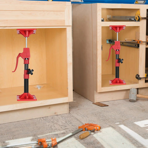 Cabinet jacks for installing cabinets: red and black adjustable support poles mounted in two cabinet openings; 2-pack.
