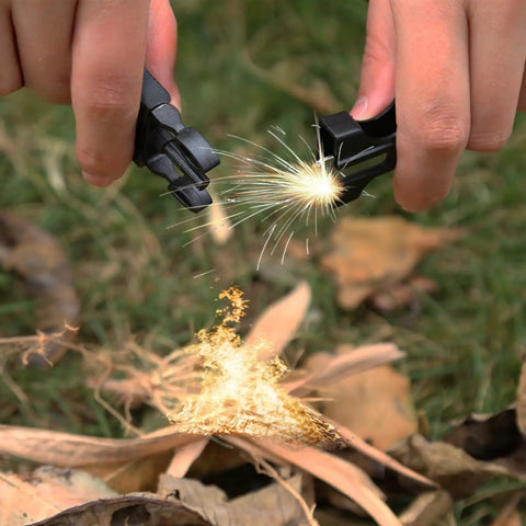 Hands using fire starter in 5 In 1 Paracord Survival Bracelet With Compass Fire Starter Whistle Glass Breaker And Paracord For Camping Hiking