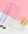 16 Piece Drawstring Threader Kit For Hoodies Jackets Coats Pants And Shorts With Elastic Threaders Loop Turner Hooks Metal Threaders Tweezers Plastic Threaders And Cord Locks For Easy Do It Yourself Repairs All In One laid out on pink surface.