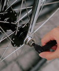 Zero Hassle Adjustable Clamping Lever Handles Built Tough With Durable Aluminum Alloy Threaded Hand Grip For Industrial Machinery Tooling Maintenance Quick Turn Ratchet Crank, close-up of hand adjusting a wheel hub.