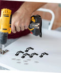 Man using a drill with black connectors, showcasing the Thirty Piece Hassle Free Furniture Connector Slide Buckle With No Sweat Tool Free Snap On Kit For Couch Sofa Wardrobe Cabinet And Bookshelf Hidden Joint Fastener Easy Home Diy Fix.