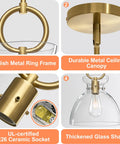 Super Sleek Brushed Gold Pendant Light For Kitchen Island featuring fully adjustable hanging cord and large clear glass shade details.