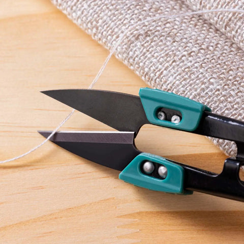 Close-up of 4.2 Inch Ultra Sharp Sewing Scissors With Wide Handle For Easy Grip Thread Snips Two Pack cutting fabric.