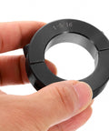 Double Split Shaft Collar For 1-5/16 Inch Shaft, Two Piece Clamping Collar, 2-1/8 Inch Outer Diameter, 9/16 Inch Width, Black Oxide Steel Lock Collar Clamp, Set Screw Style, Heavy Duty And Corrosion Resistant, hand holding black collar